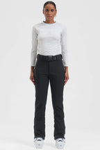 Black women's slim-fit ski pants by Les Odettes, fleece-lined and wearable for winter outdoor activities.