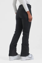 Black women's slim fit fleece-lined ski pants by Les Odettes, shown with a close-up of the waistband and fabric texture.