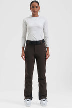 Women's black Les Odettes ski pants with slim fit, fleece-lined interior, designed for cold weather and active winter sports.
