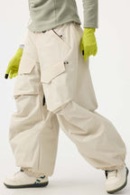 Women's black baggy utility snow pants by Les Odettes with wear-resistant fabric and adjustable waist for outdoor winter activities.