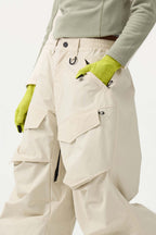 Women's black baggy utility snow pants by Les Odettes, weather-resistant with reinforced wear-resistant fabric, shown on a model.