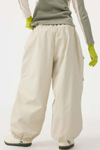 Women's black baggy utility snow pants by Les Odettes, wear-resistant and designed for winter outdoor activities.