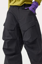 Women's black baggy utility snow pants by Les Odettes, wear-resistant fabric, with adjustable waist and multiple pockets.