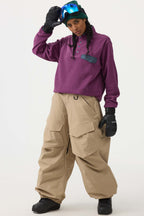 Les Odettes women's black baggy utility snow pants with wear-resistant fabric, suitable for winter outdoor activities.