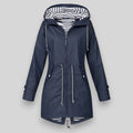 Noa™ waterproof jacket by Les Odettes, sleek coat with a modern fit, shown on a model in a city outdoor setting.
