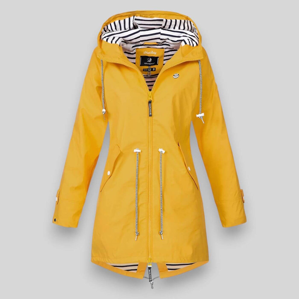 Noa™ waterproof jacket by Les Odettes, sleek and stylish coat designed for rain protection, shown on a model in an outdoor setting.