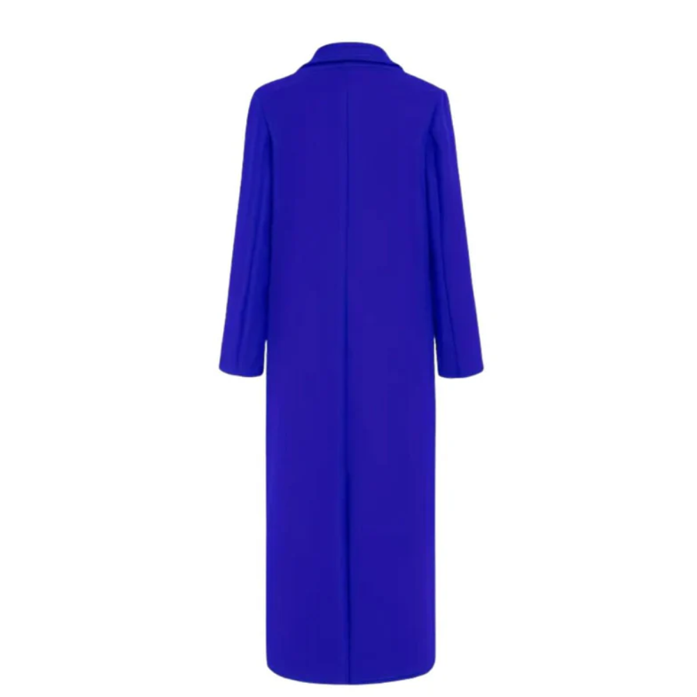 Longline winter trench coat by Les Odettes with classic collar, button closure, and tailored fit in a neutral color.