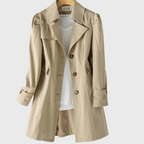 Les Odettes Merivel™ everyday rain coat in navy with hood, waterproof fabric, and button closure, displayed on a hanger.