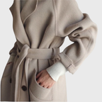 Longline black overcoat from Les Odettes' Crizza™ collection, featuring a tailored fit and classic design, shown on a model.