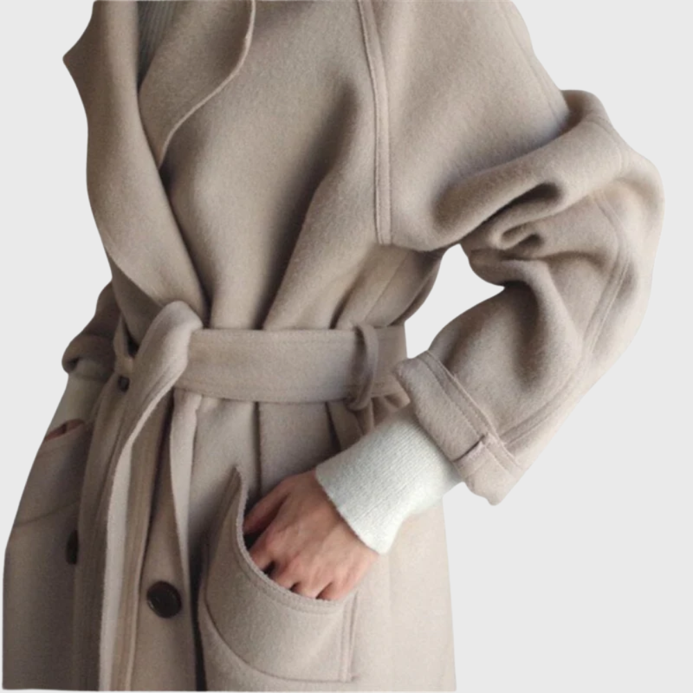 Longline black overcoat from Les Odettes' Crizza™ collection, featuring a tailored fit and classic design, shown on a model.