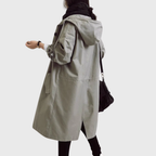 Les Odettes Arline™ waterproof trench coat displayed on a hanger, showing its classic design and lightweight fabric.