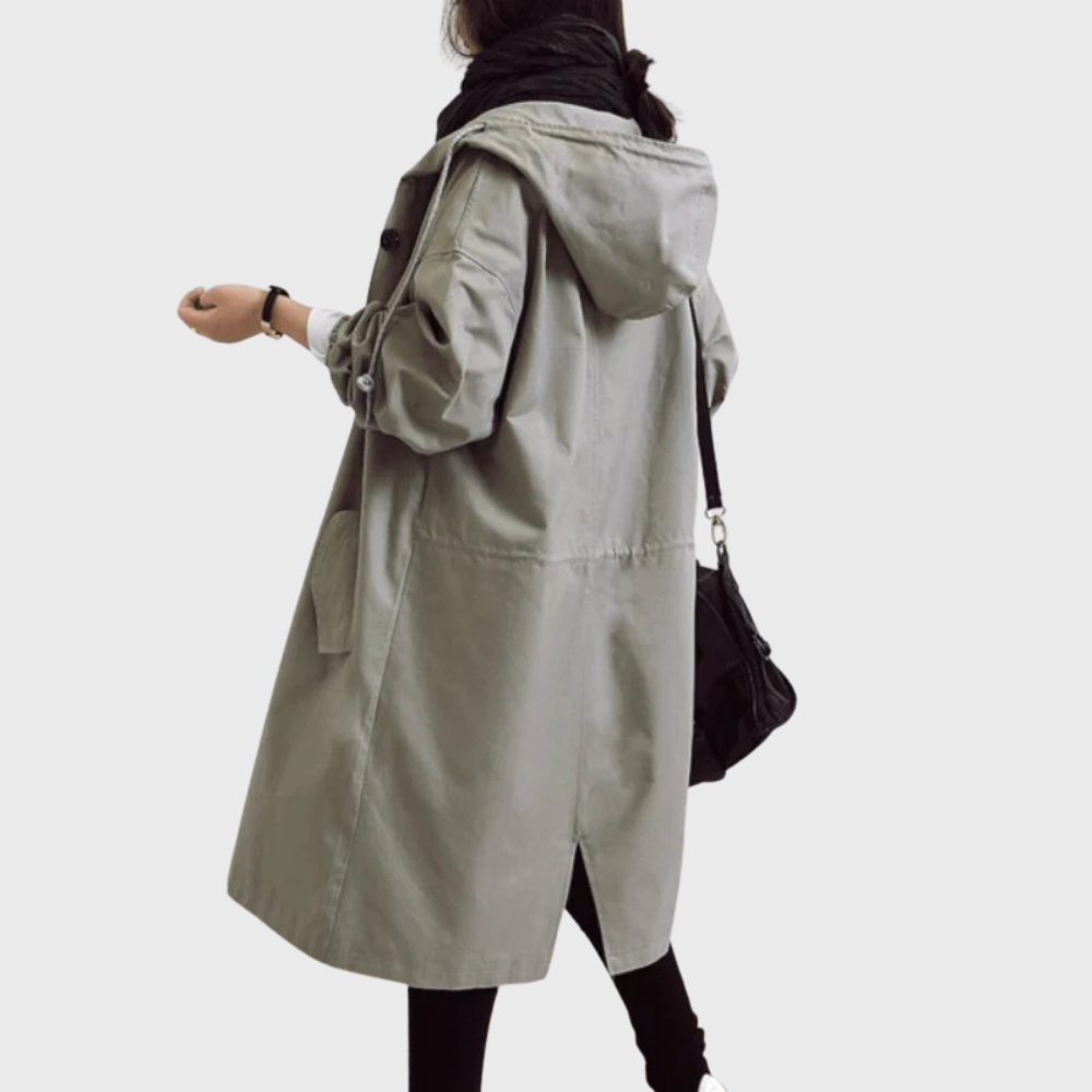 Les Odettes Arline™ waterproof trench coat displayed on a hanger, showing its classic design and lightweight fabric.
