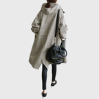 Black Arline™ waterproof trench coat by Les Odettes displayed on a mannequin, showcasing its classic tailored design and rain-resistant fabric.