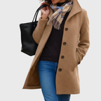 Les Odettes Kimmy™ longline coat in a flattering design, shown in a stylish, neutral-toned fabric with a tailored fit.