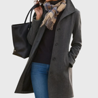 Les Odettes Kimmy™ longline coat featuring a flattering, elegant design with a tailored fit and stylish collar detail.