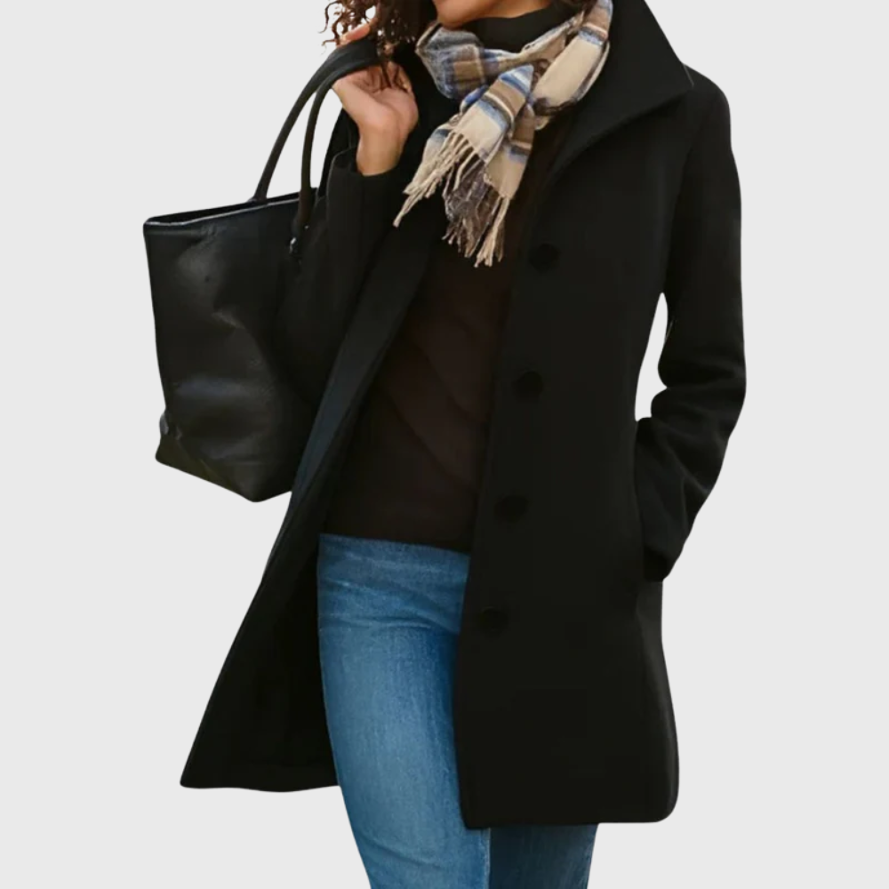 Kimmy™ longline coat by Les Odettes in a flattering style, featuring a tailored fit and classic design, shown in a stylish outdoor setting.