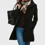 Kimmy™ longline coat by Les Odettes in a flattering style, featuring a tailored fit and classic design, shown in a stylish outdoor setting.