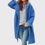 Les Odettes Crishna™ Warm Classic Coat displayed on a hanger, showcasing its cozy fabric and elegant design.