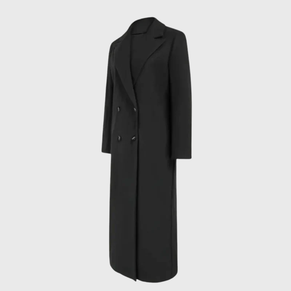Longline winter trench coat by Les Odettes featuring a classic design, shown in black with button details and a belted waist.