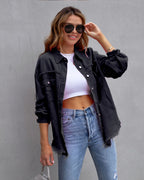 Les Odettes Tricia vintage-inspired jacket in black, shown on a hanger with detailed stitching and classic design.