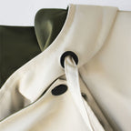 Aurelía™ windbreaker jacket by Les Odettes, lightweight outdoor jacket with a hood and adjustable drawstrings, in a neutral color.