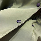 Aurelia™ windbreaker jacket by Les Odettes, lightweight waterproof outerwear in sleek design, shown on a hanger.