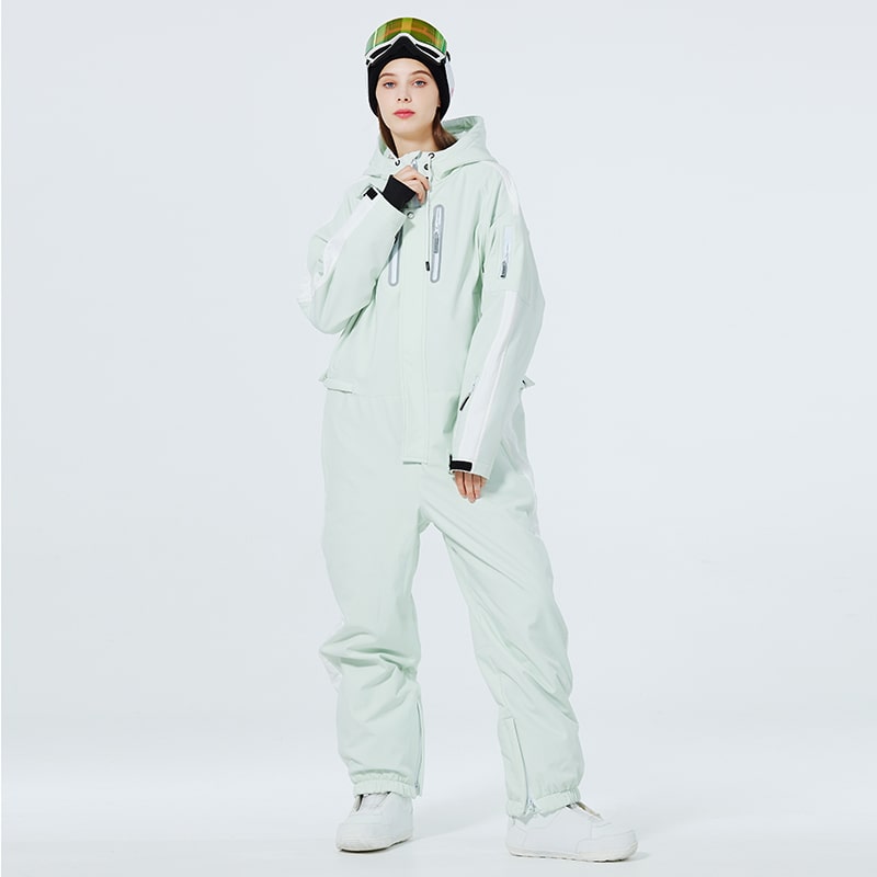 Les Odettes Women's AlpineChill SnowStorm one-piece snowsuit in vibrant winter colors, designed for cold weather outdoor activity.