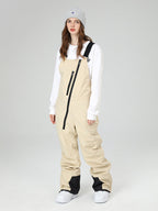 Les Odettes women's snow pants with oblique zipper details, winter crew ski bibs, featuring a fitted design and snow-resistant fabric.