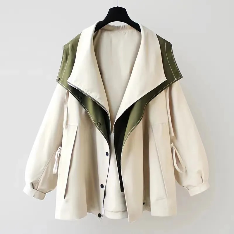 Les Odettes Aurelia™ windbreaker jacket in lightweight fabric, featuring a zip front, hood, and adjustable cuffs for outdoor wear.