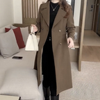 Les Odettes Stella™ sophisticated trench coat displayed on a hanger, featuring classic design with belt and double-breasted style.