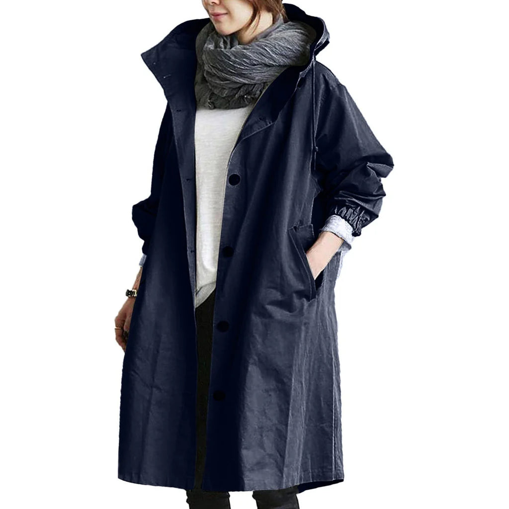 Dark blue women's waterproof raincoat with hood, lightweight design, by Les Odettes, suitable for rainy weather.