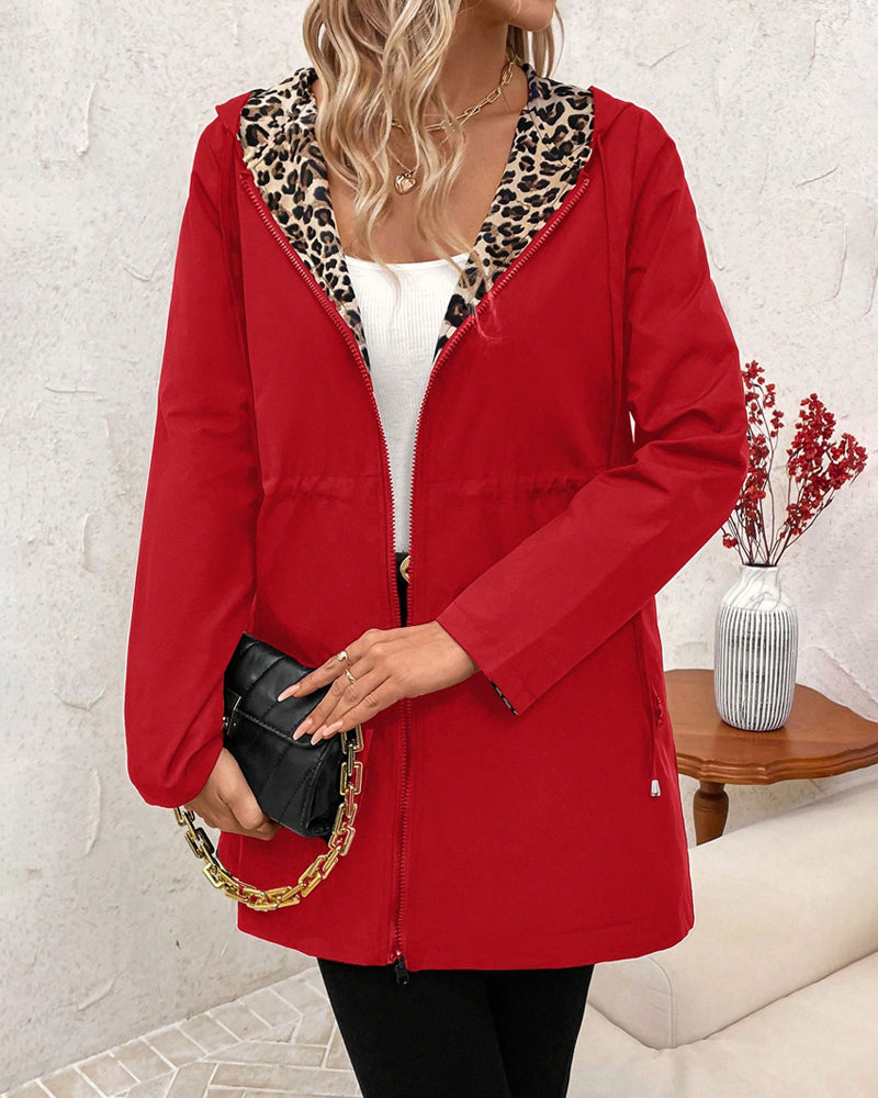 Aleah™ reversible coat by Les Odettes featuring a stylish leopard print, shown folded open with one side displaying the animal pattern.