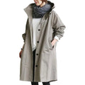 Gray women's waterproof raincoat with hood from Les Odettes, lightweight design perfect for rainy days.