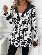 Les Odettes Aleah™ reversible coat featuring a stylish leopard print, shown with both solid and leopard sides visible.