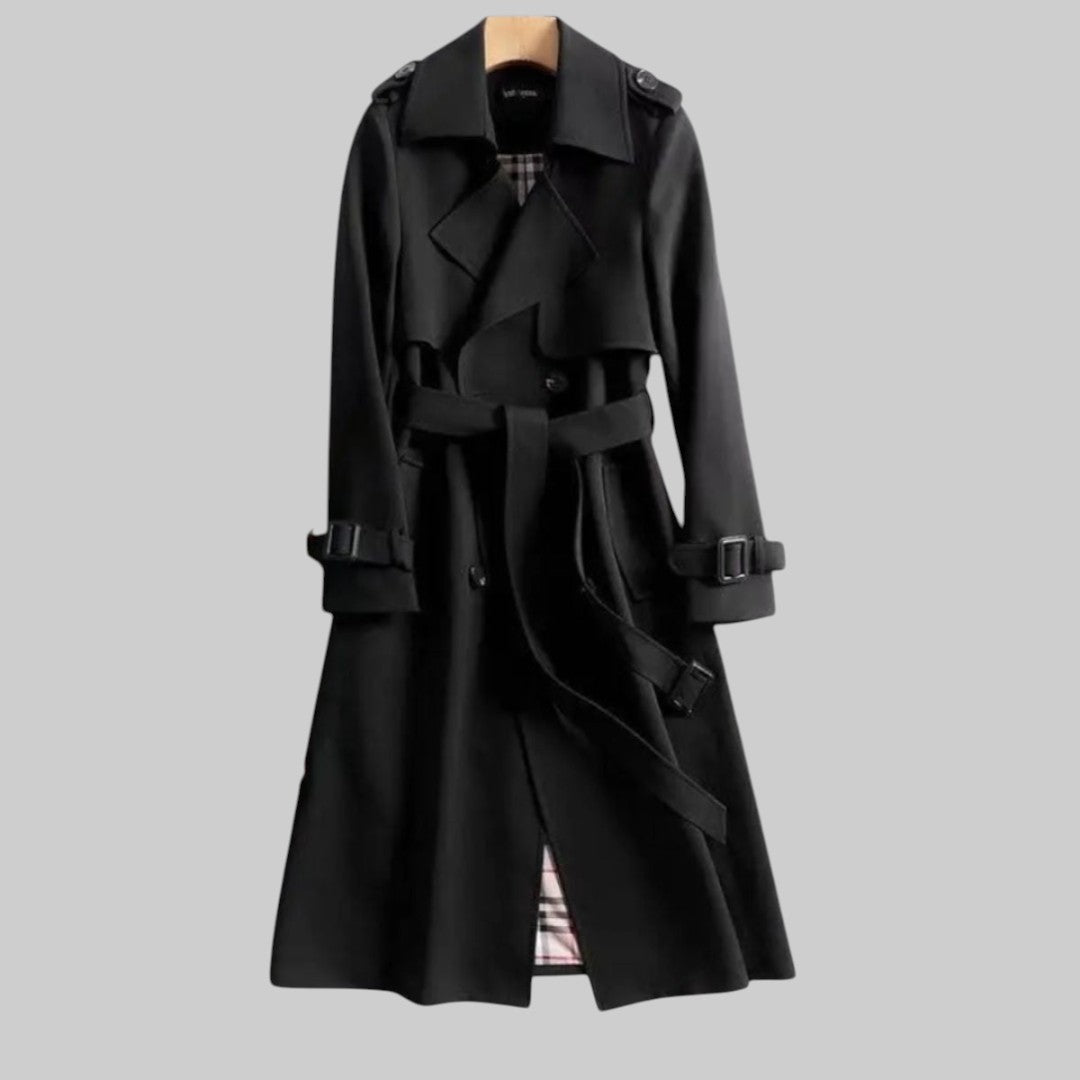 Les Odettes Aleah™ classic trench coat in beige, shown hanging on a wooden hanger with a belt and double-breasted design.
