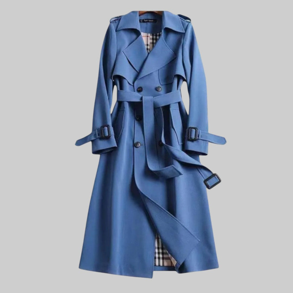 Les Odettes Aleah™ classic trench coat in beige, shown on a model with a double-breasted design and belt, full-length view.