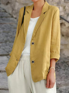 Les Odettes Juniper women's double-breasted tailored blazer hanging on a hanger, showcasing classic design and structured fit.