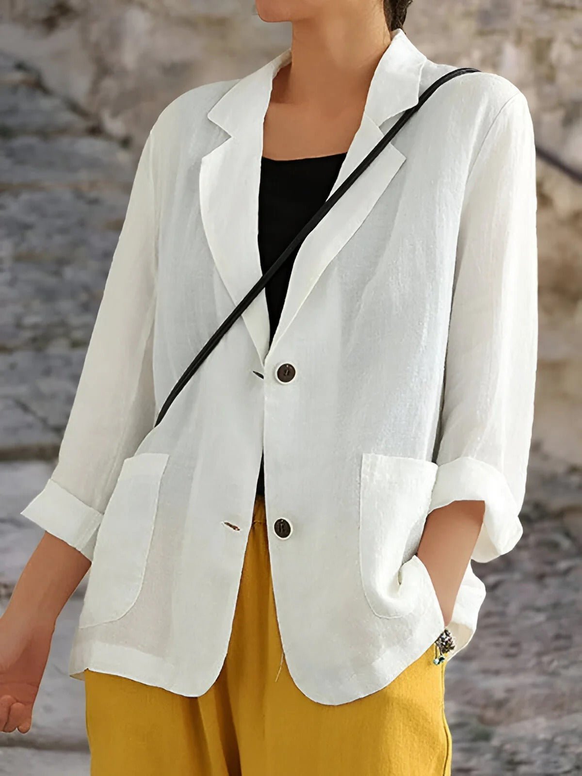 Les Odettes women's double-breasted tailored blazer in deep green, featuring structured lapels and a fitted silhouette.