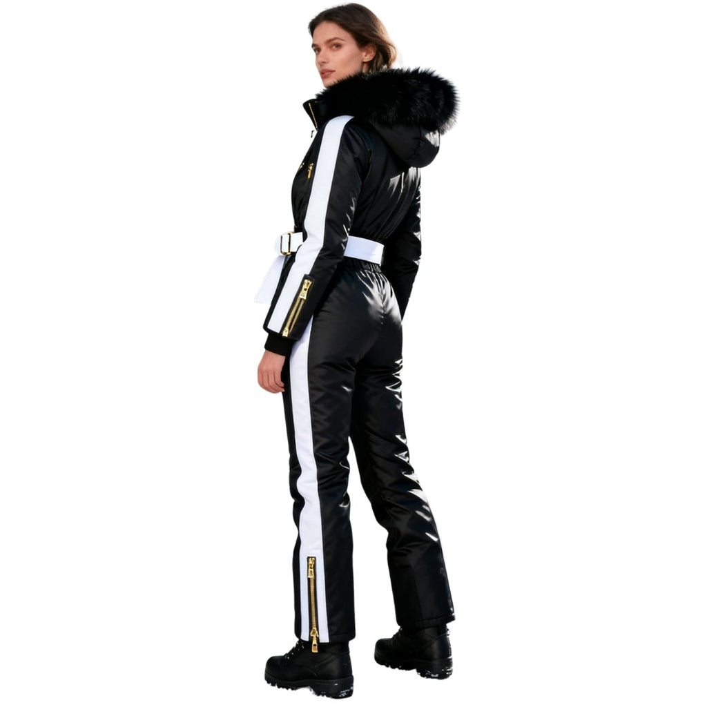 Les Odettes Dolly Glamour Ski Suit Monosuit in black and white with fur-lined hood, back view showcasing belted waist and stylish design.