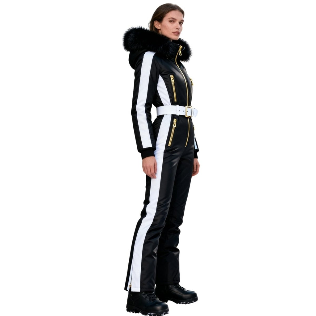Les Odettes Dolly Glamour Ski Suit Monosuit with belted waist, black and white fur-lined hood, designed for winter outdoor activities.