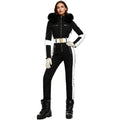 Black and white women's ski suit by Les Odettes featuring a belted one-piece snowsuit with fur-lined hood and waterproof, stretch fabric.