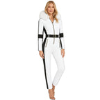 White women's one-piece ski suit by Les Odettes with fur-lined hood, waterproof and stretchy for winter snowboarding and skiing.