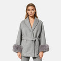 Dark brown mink fur vest with zip front, sleek design, layered over a gray wool coat with faux fur cuffs, stylish luxury piece.