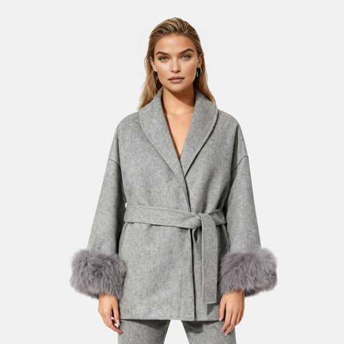 Dark brown mink fur vest with zip front, sleek design, layered over a gray wool coat with faux fur cuffs, stylish luxury piece.