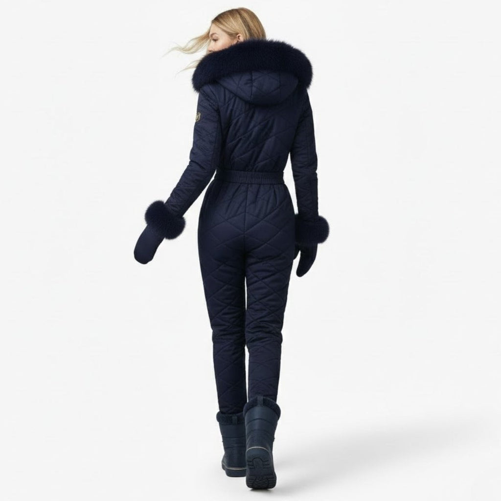 Navy blue women's quilted ski suit by Les Odettes, back view showing insulated design and fit for winter skiing.