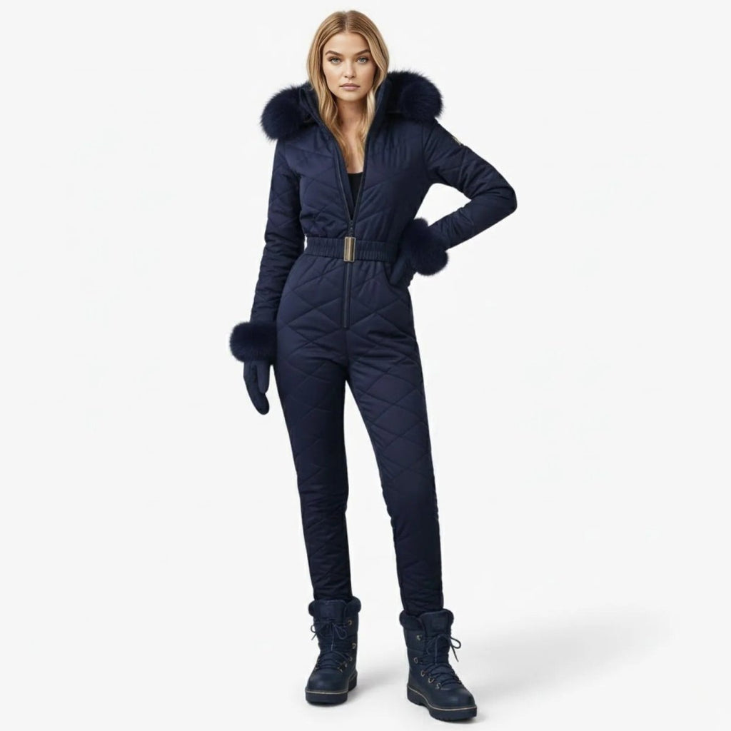 Navy blue women’s quilted ski suit by Les Odettes, front view showing insulated, fitted design for winter snowboarding or skiing.