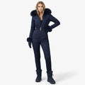 Navy blue women’s quilted ski suit by Les Odettes, front view showing insulated, fitted design for winter snowboarding or skiing.
