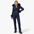 Navy blue women’s quilted ski suit by Les Odettes, front view showing insulated, fitted design for winter snowboarding or skiing.