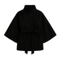 Black women's sculptural wool blend cape jacket with belt, styled as outerwear, front and back views.