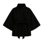 Black women's sculptural wool blend cape jacket with belt, styled as outerwear, front and back views.